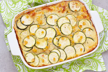 casserole with zucchini, corn and potato in baking dish