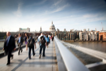 Blurred background of crowd of people on millennium bridge and st pauls cathedral in background,...