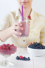 Close up of a young woman drinking a smoothie
