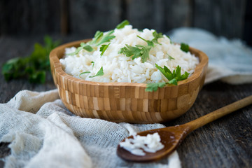 Boiled rice in a plate with greens