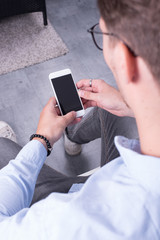 smart young professional looking on his smartphone