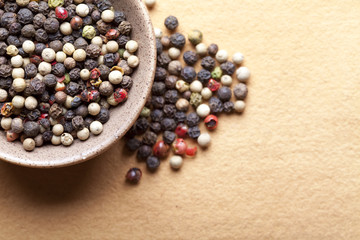 Mix of pepper peas in bowl on paper background
