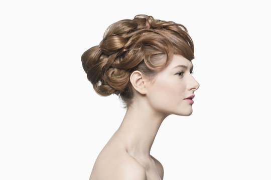 Profile view of beautiful woman with hairstyle against white background