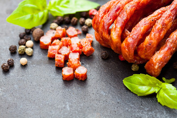 Tasty  pork sausages with spices and basil leaves