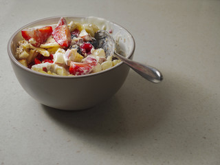 Bowl with fruit and muesli salad.