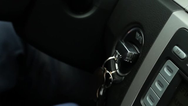 Man starts the car with key.