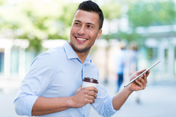 Young man with digital tablet outdoors
