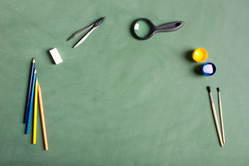 School accessories on the green background