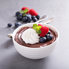 Chocolate pudding with whipped cream and berries