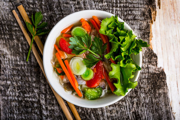 Bowl of Thai soup with fresh ingredients