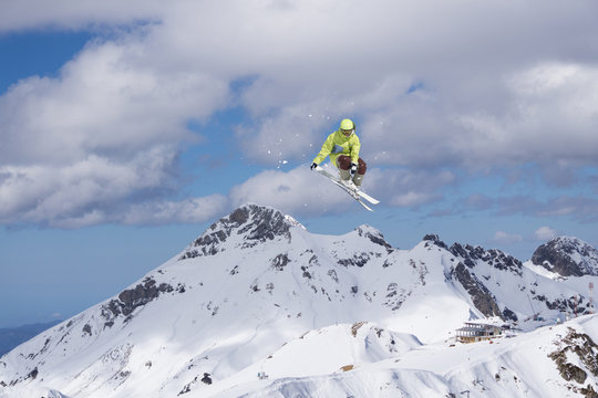Ski rider jumping on mountains. Extreme ski freeride sport.