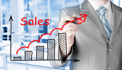 business man drawing graph of sales