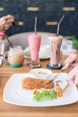 eating steak on wood table with Beverages background
