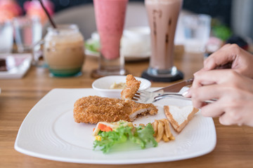 eating steak on wood table with Beverages background