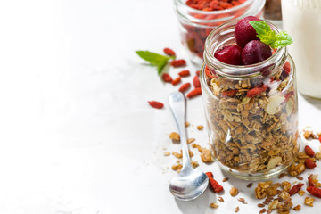 healthy food, granola with goji berries and cherries in a glass