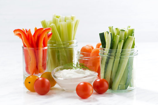 healthy snacks, mixed vegetables and yogurt on white background