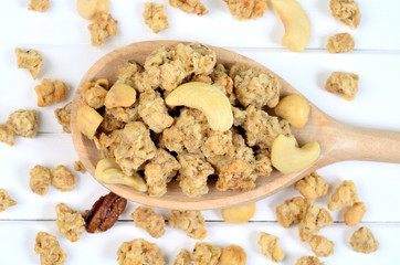 Muesli in wooden spoon on table
