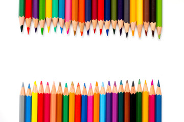 Row of color pencil placed on white background