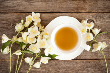 Top view of teacup and blooming flowers