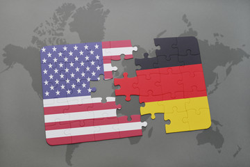 puzzle with the national flag of united states of america and germany on a world map background