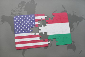 puzzle with the national flag of united states of america and hungary on a world map background