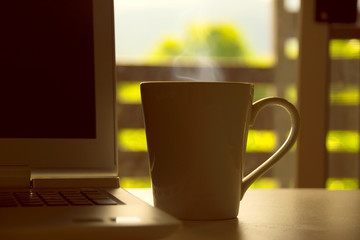 Hot drink cup and Laptops Notebook Computers on table