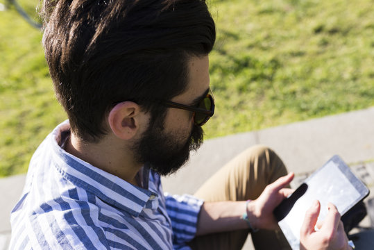 Young man using mini tablet