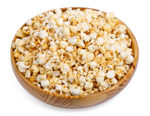 Popcorn in a wooden bowl on a white background