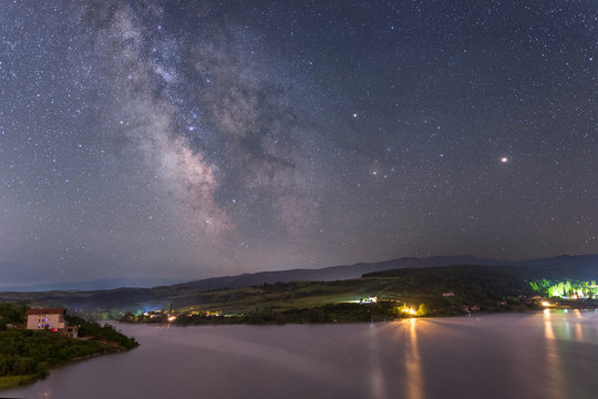 Milky way over lake Cincis in Romania with Mars and Saturn