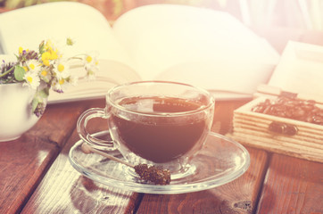 cup of coffee on a wooden backgound. Flowers and grass. Natural background. Agricultural.Garden 