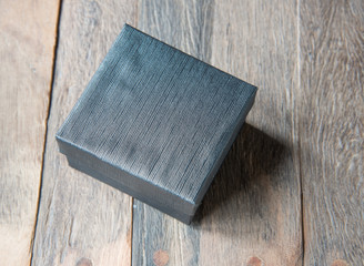 Black box on wood texture.