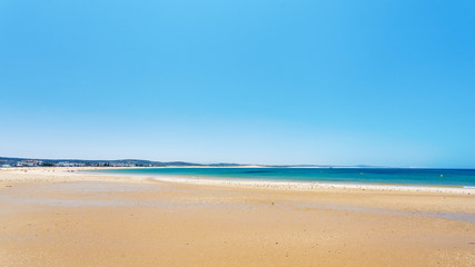 Fototapeta na wymiar Clear blue sky over emerald sea and yellow sandy beach, Agadir, Morocco