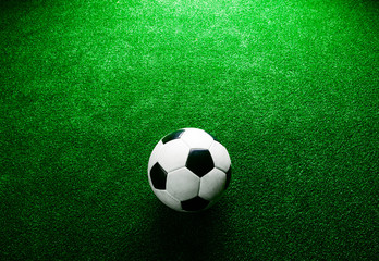 Soccer ball against artificial turf. Studio shot. Copy space.