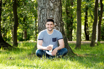 Man with coffee in park