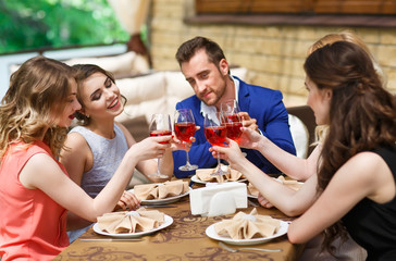 Friends drinking wine on the summer terrace.