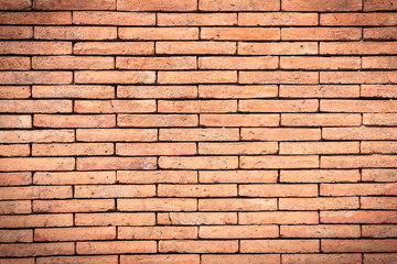 Obraz premium Closeup orange brick wall texture for background. Grunge retro vintage of brick wall. Part of old brick wall for design with copy space for text or image. Dark edged.