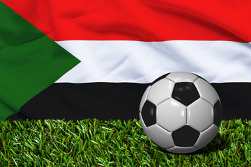 Soccer Ball on Grass with Sudan Flag Background, 3D Rendering