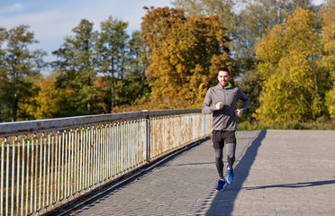 Fototapeta premium happy young man running over city bridge