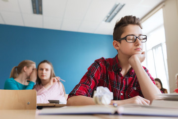 students gossiping behind classmate back at school