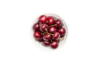 Cherries in white bowl isolated on white