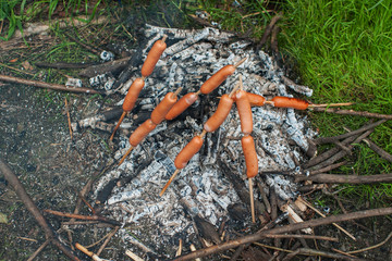 grilled sausages on camp fire