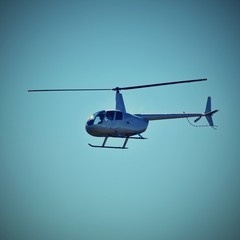 Helicopter flying against the blue sky
