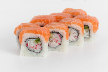 Sushi rolls with salmon and cucumber on a white background