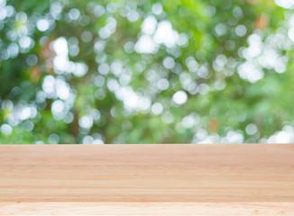 Wood table top on bokeh nature green background