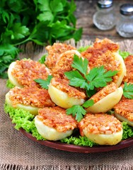 Baked potatoes with ham, cheese, bread crumbs and egg.