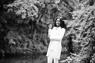 Stylish black african american girl posing on park background ri