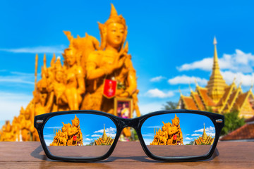 eyeglasses on wooden table front of Thai candle festival at Ubon ratchathani,Thailand  selective...