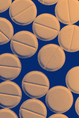 Strewn pills on dark background