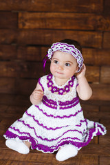 Cute little girl on a wooden background.