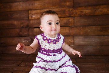 Cute little girl on a wooden background.